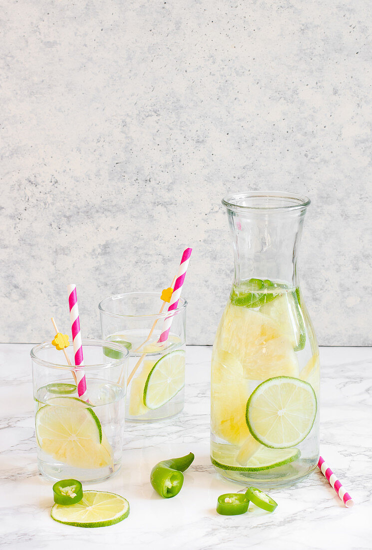 Summer lime lemonade with chilli in a karafe and glasses