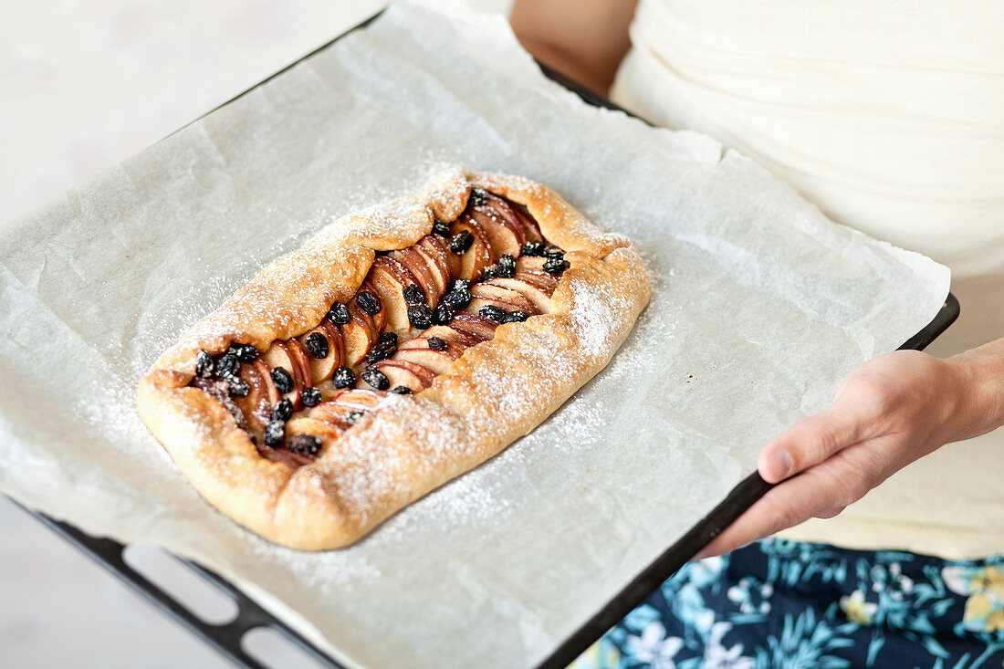 Apple tart with raisins on a baking tree