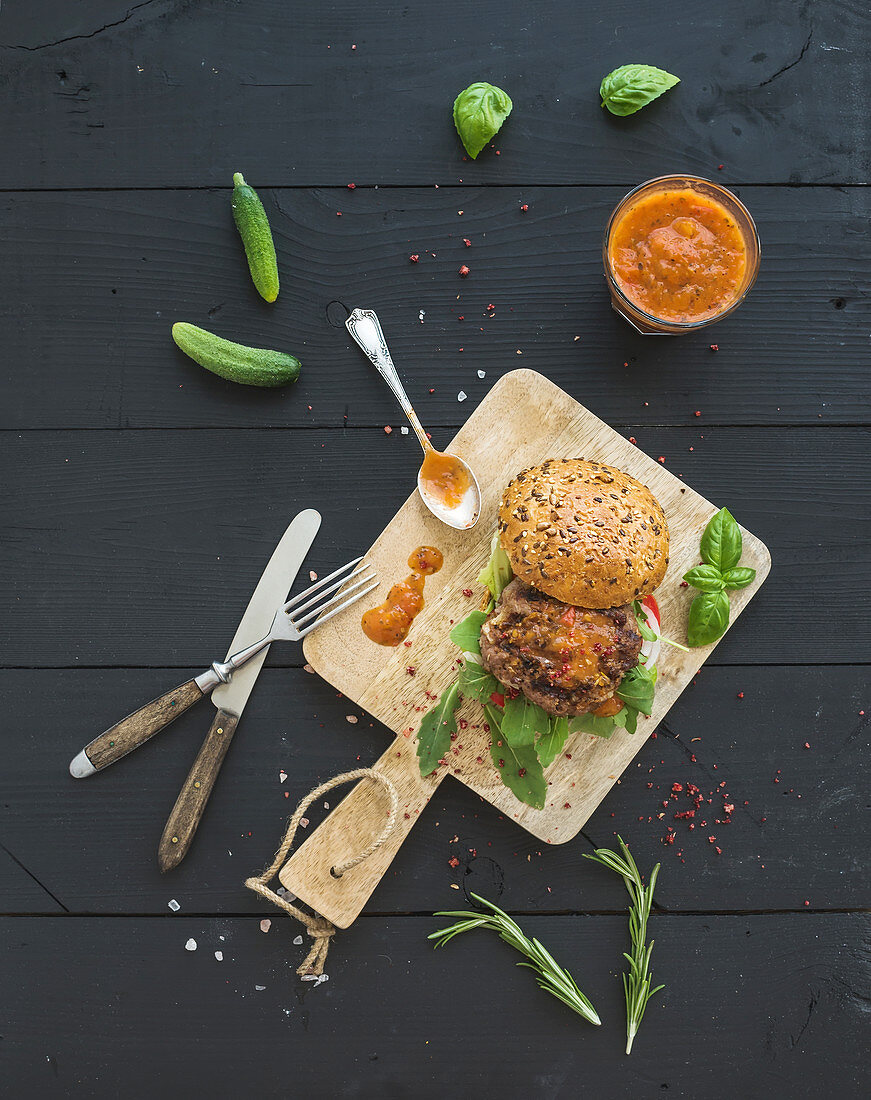 Fresh homemade burger with spicy tomato sauce, sea salt and herbs