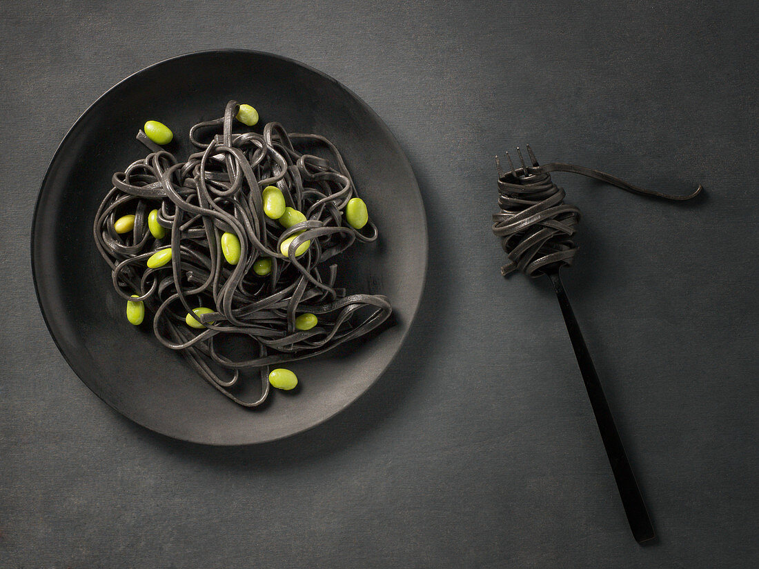 Black pasta with broad beans