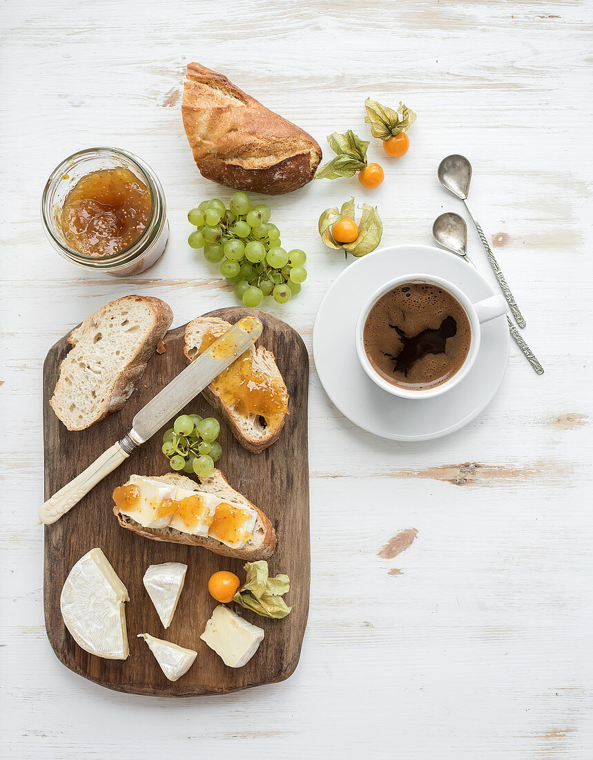 Brie cheese and fig jam sandwiches with fresh grapes and ground cherries