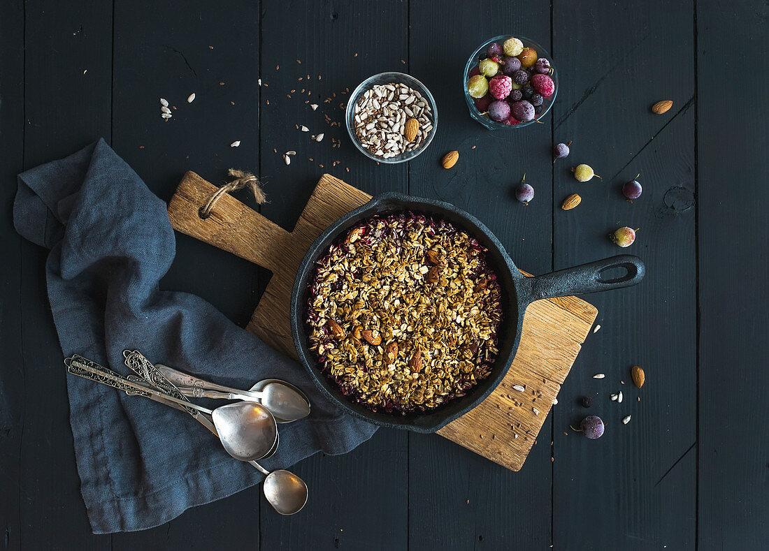 Healthy breakfast - Oat granola crumble with frozen fresh berries, and seeds