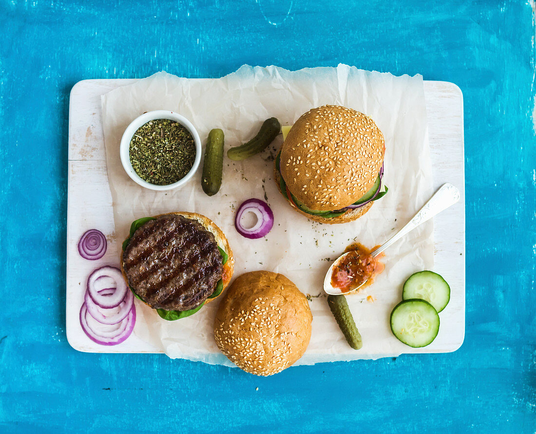 Fresh beef burger with cheese, vegetables and spicy tomato sauce