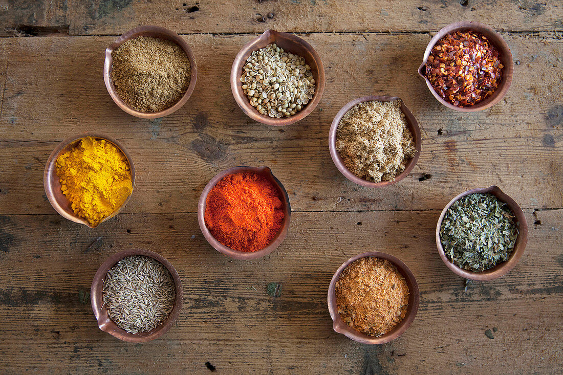 Assorted spices in copper bowls