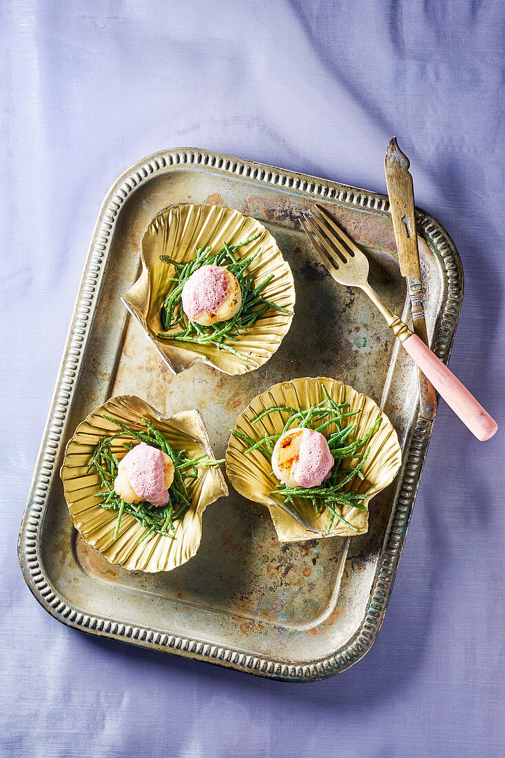 Scallops served with glasswort served in gilded shells