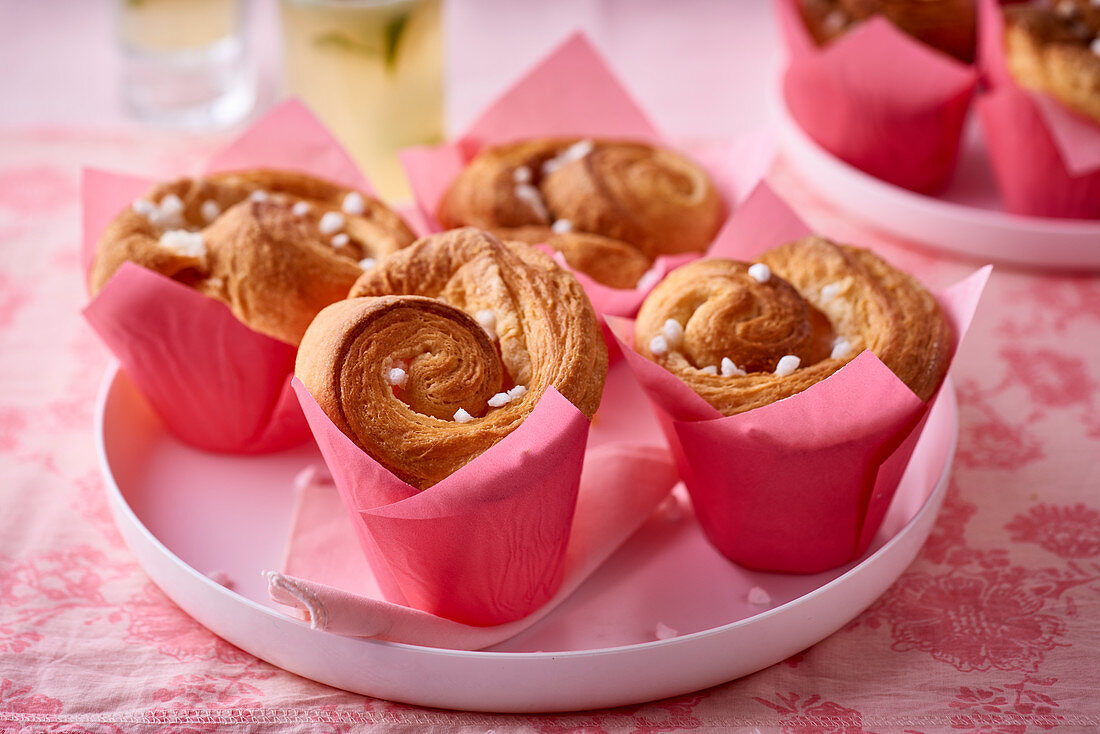 Small puff pastry brioches in pink paper cups