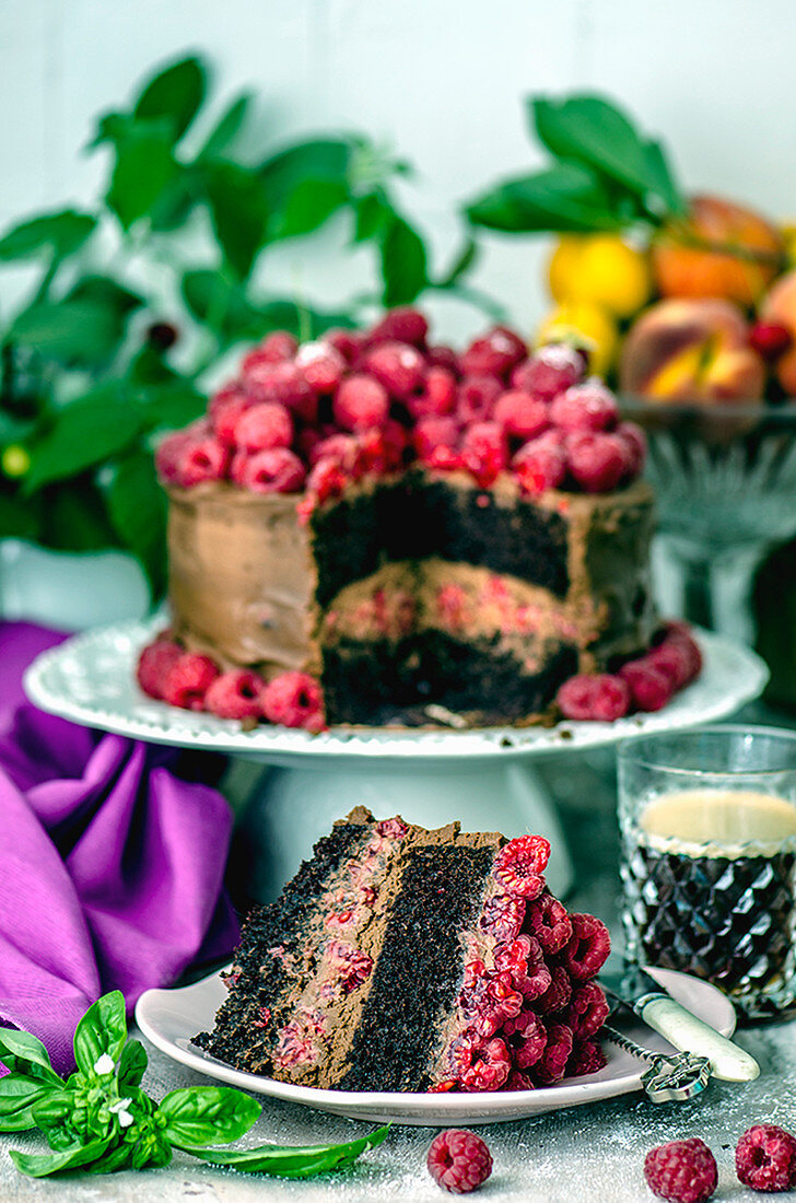 Chocolate cake with raspberries and coffee in a crystal glass