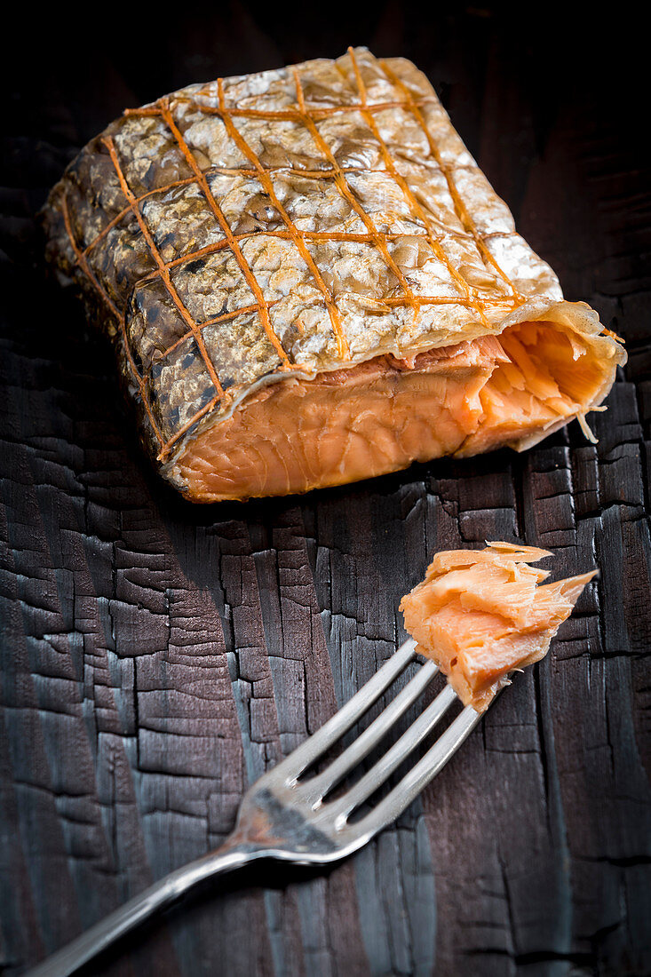 Smoked salmon in a net with a fork