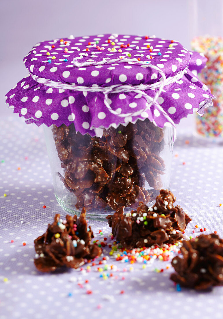 Homemade chocolate cornflake cakes with cranberries in a jar for Christmas