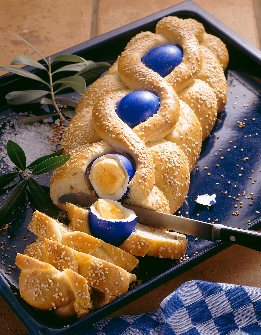 Spicy Greek Easter bread made with onions, bacon and blue Easter eggs