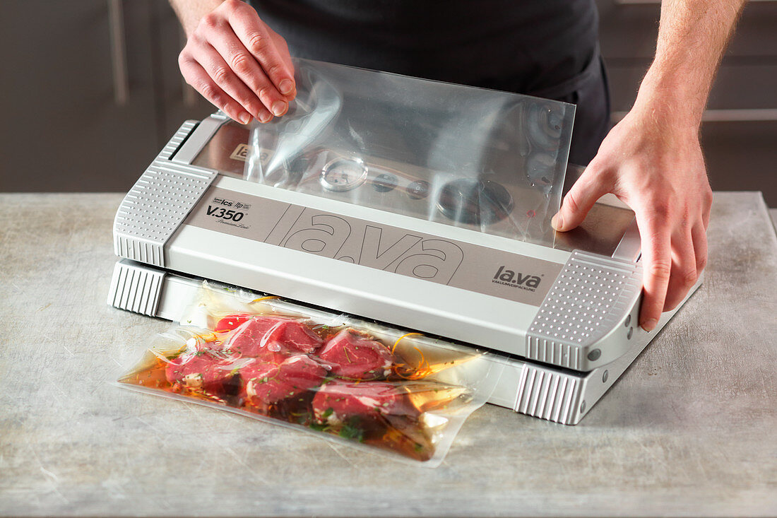 Meat and juices being vacuum packed without air intake