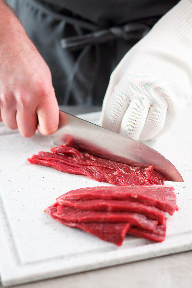 Beef being thinly sliced