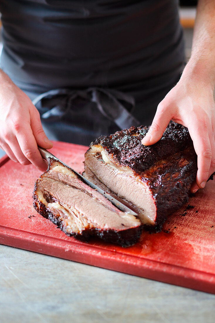 Cured beef brisket being sliced