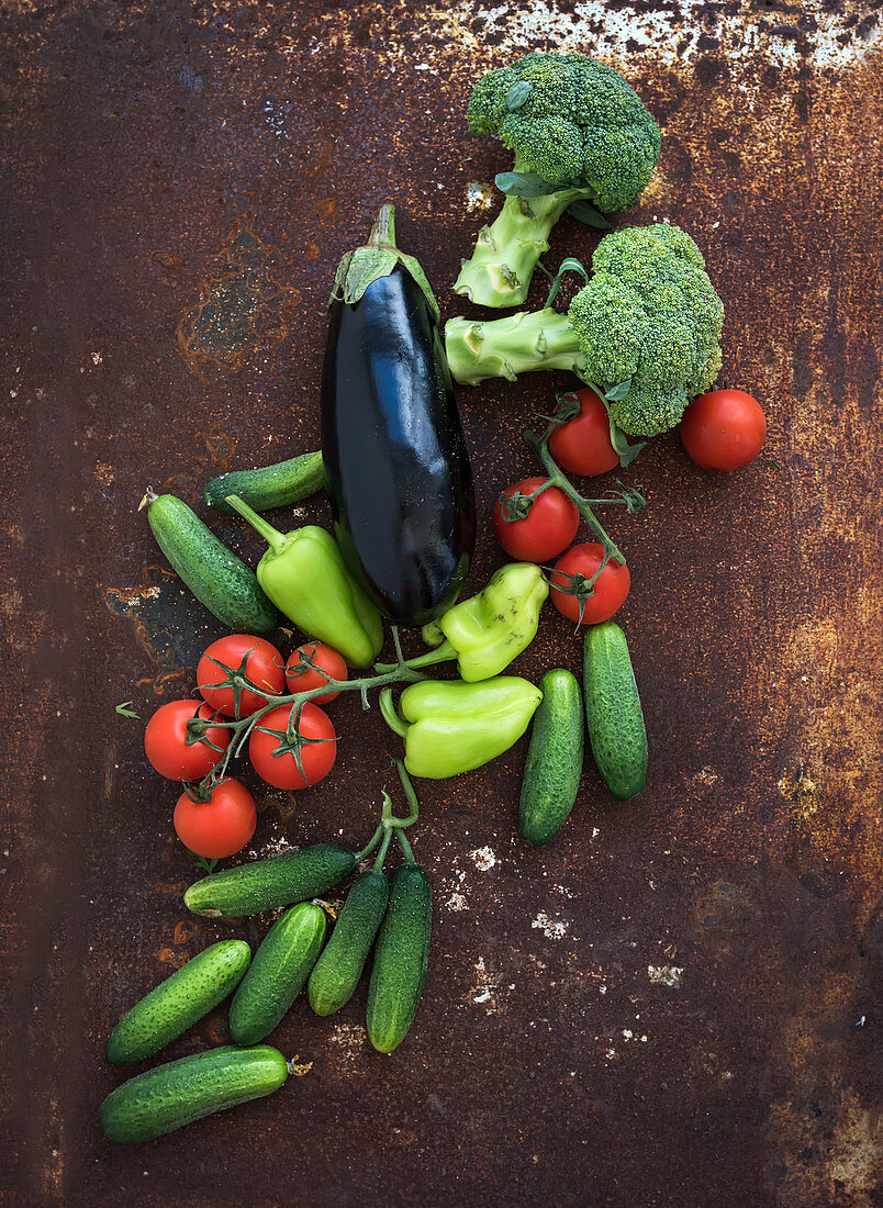 Vegetable mix of garden cherry tomatoes, cucumbers, paprikas, eggplant and broccoli