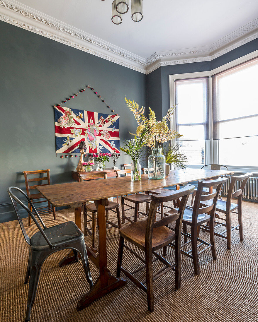 Vintage-style dining room in period interior with grey walls and bay window