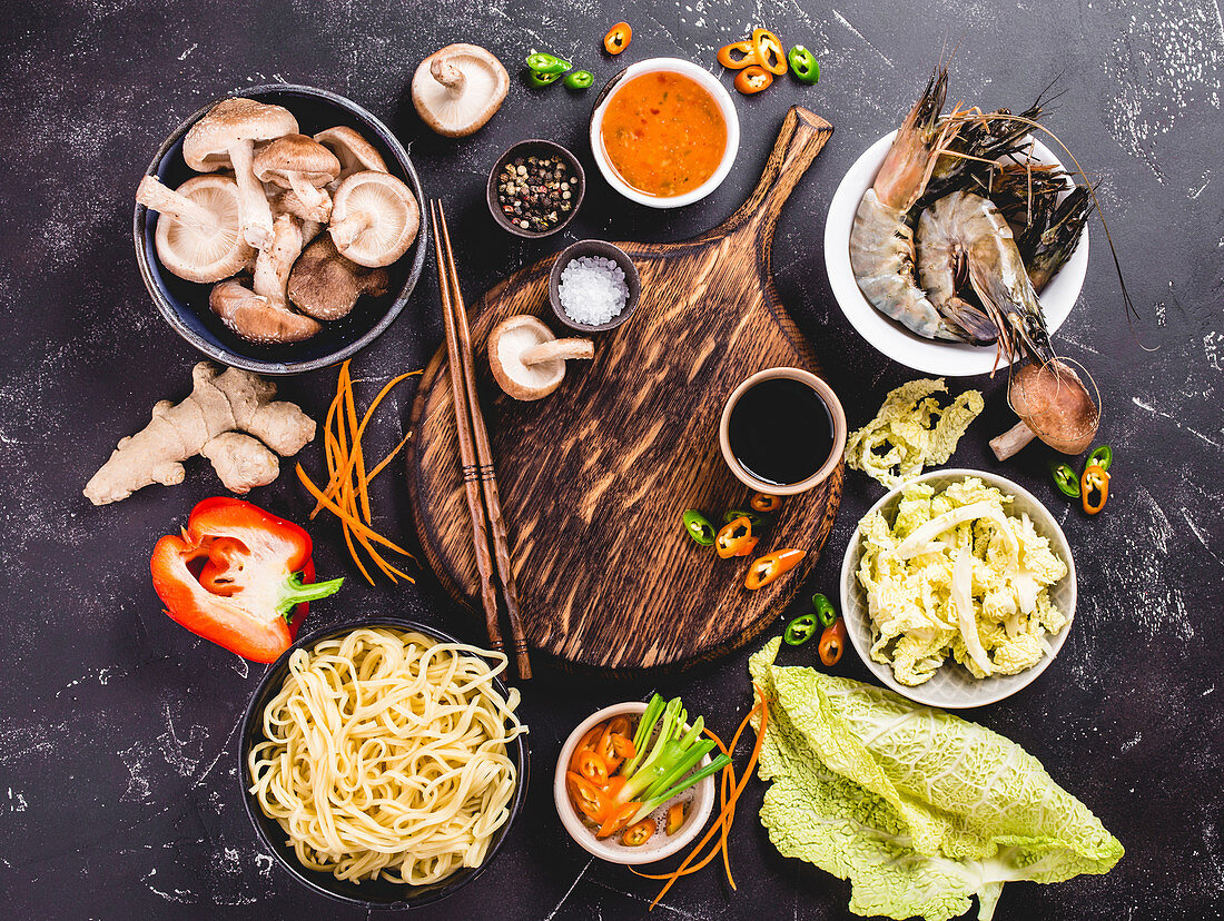 An arrangement of ingredients for an oriental noodle dish with prawns, mushrooms and vegetables