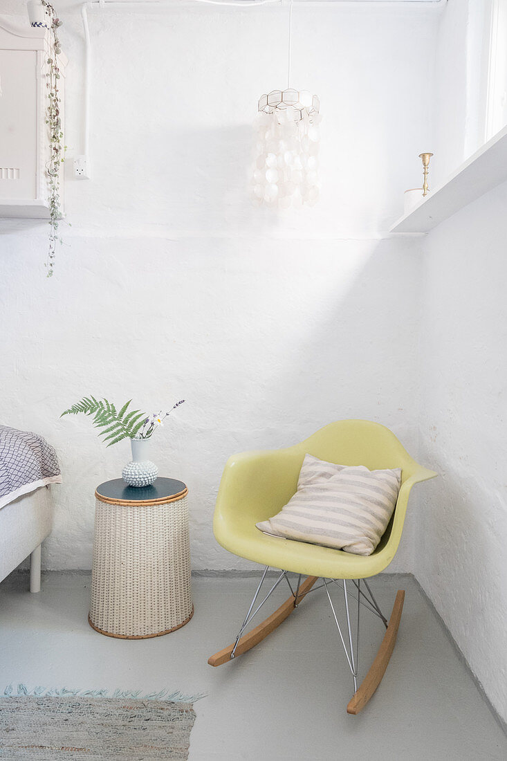 Yellow rocking chair in basement bedroom