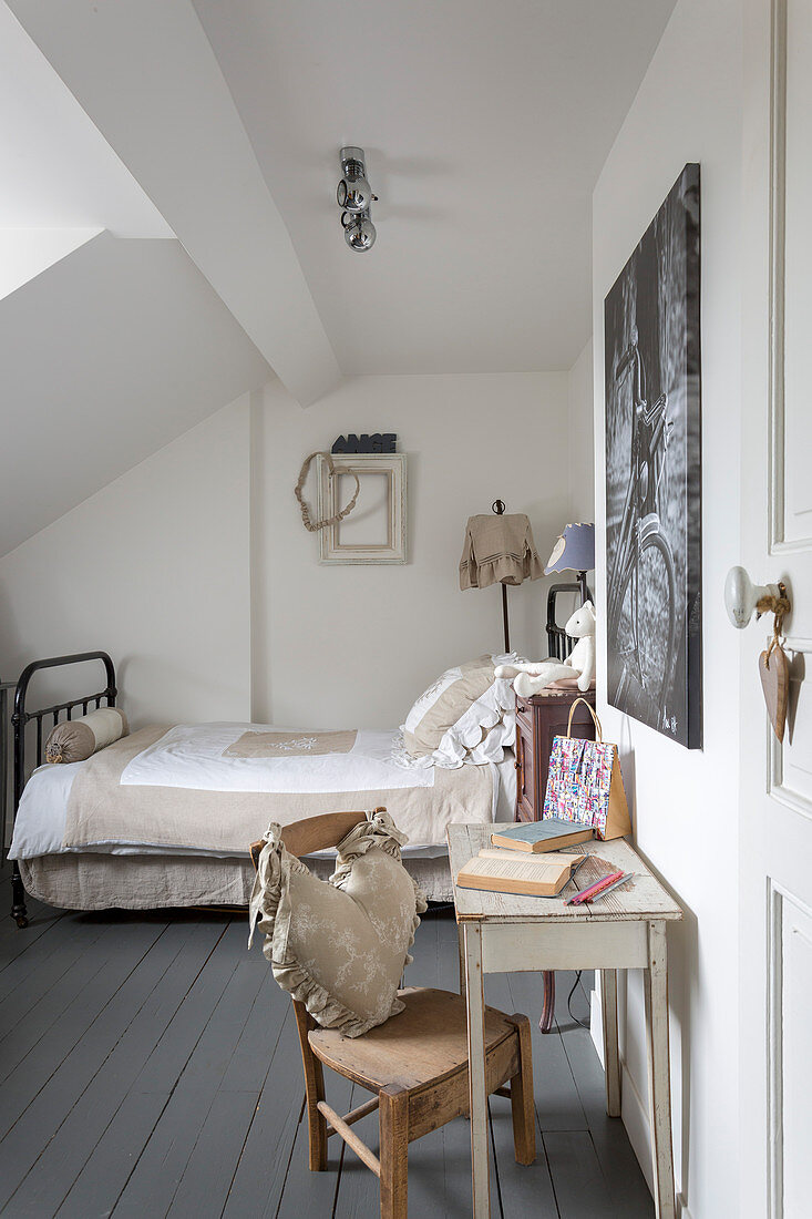 Bed, console table and chair in guest room