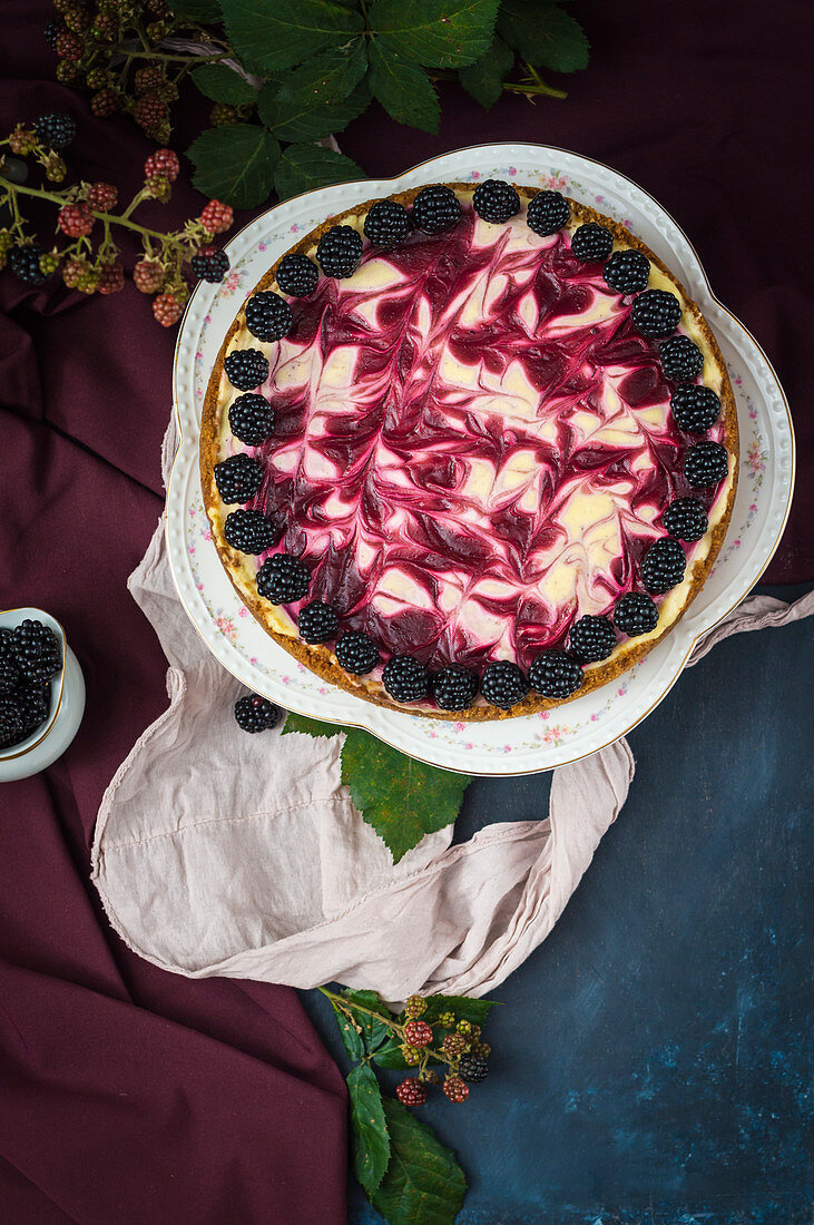 Blackberry swirled cheesecake on romantic cake stand (seen from above)
