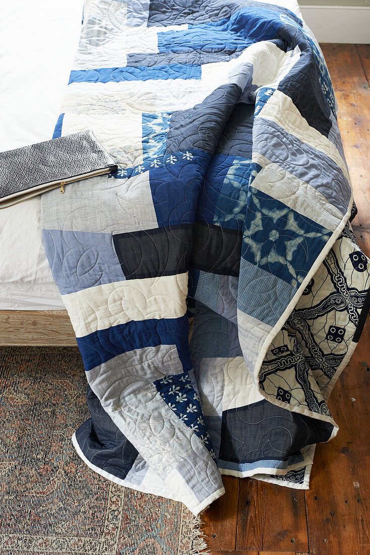 Blue and white quilt on bed