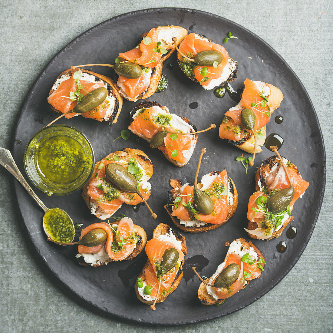 Salmon crostini with cream-cheese, watercress, capers and pesto sauce