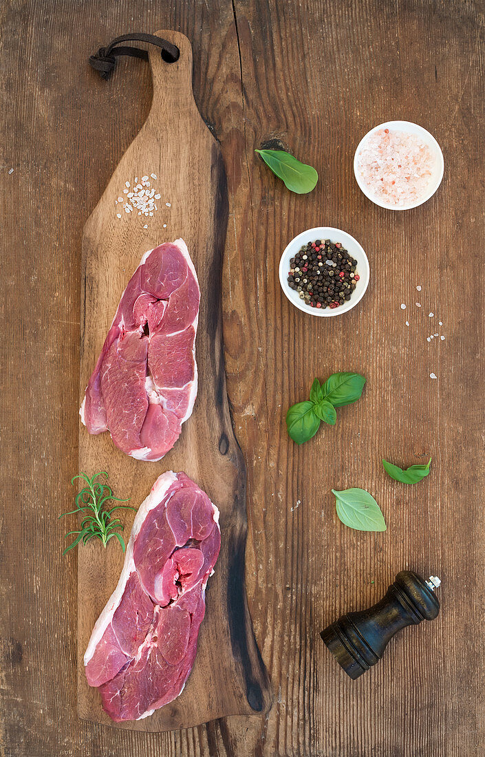 Lamb entrecote and seasonings on cutting board