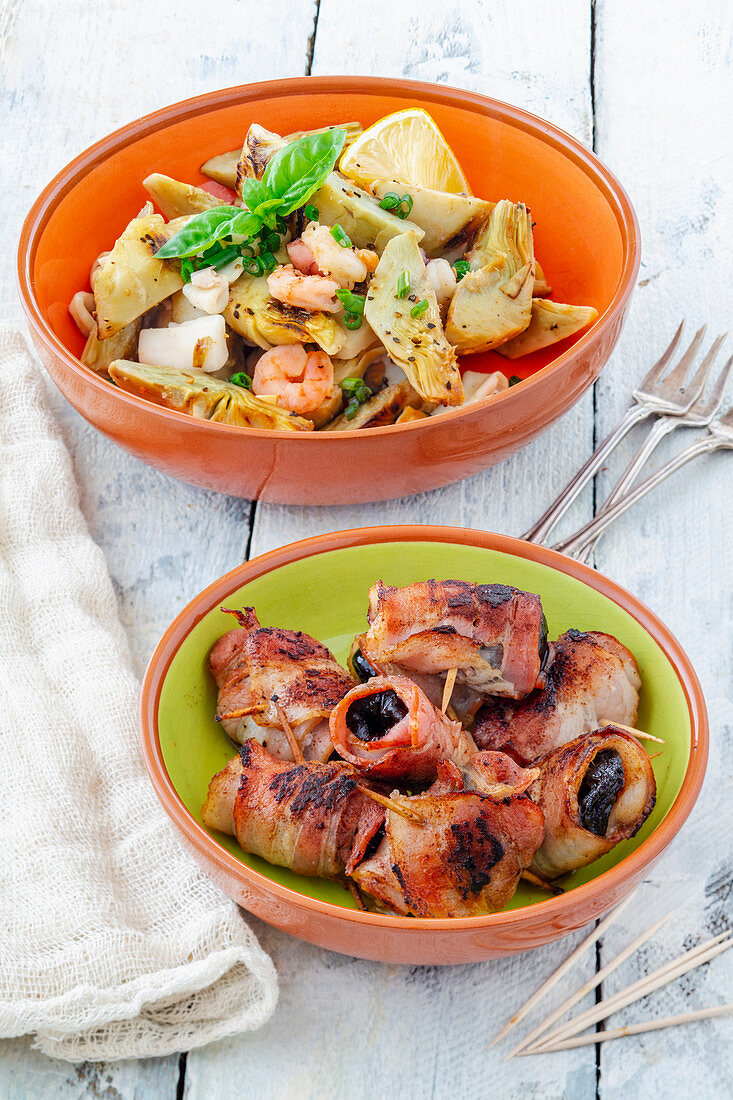 Tapas: artichoke salad and prunes wrapped in bacon (Spain)