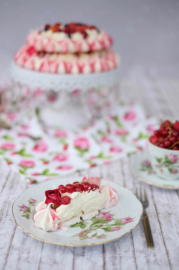 A festive pavlova with red berries and rose syrup
