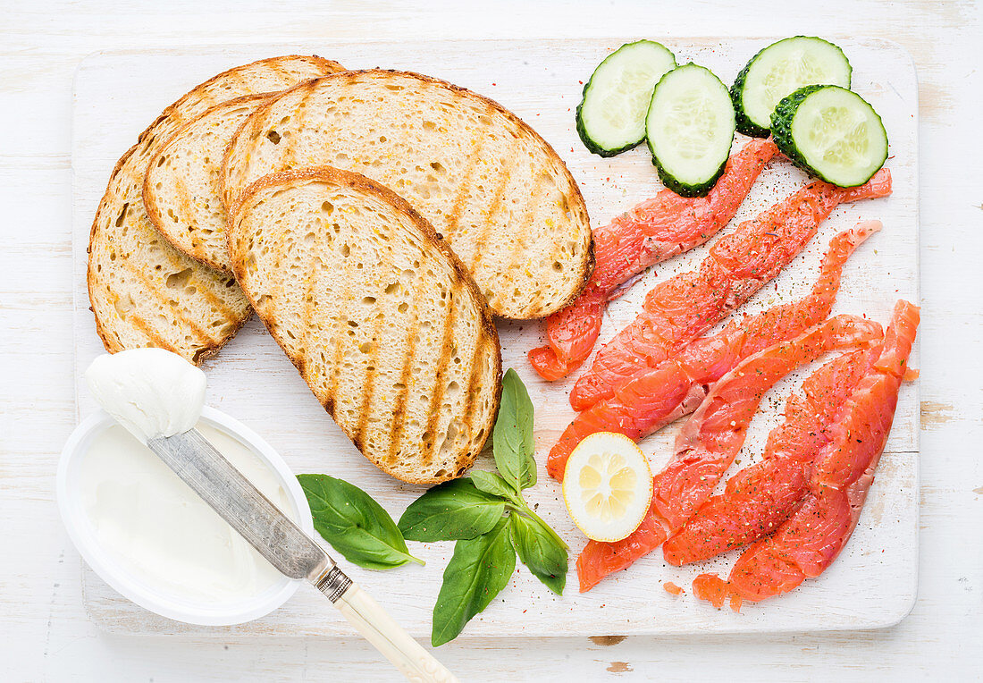 Grilled bread slices, smoked salmon, cottage cheese, cucumber and basil