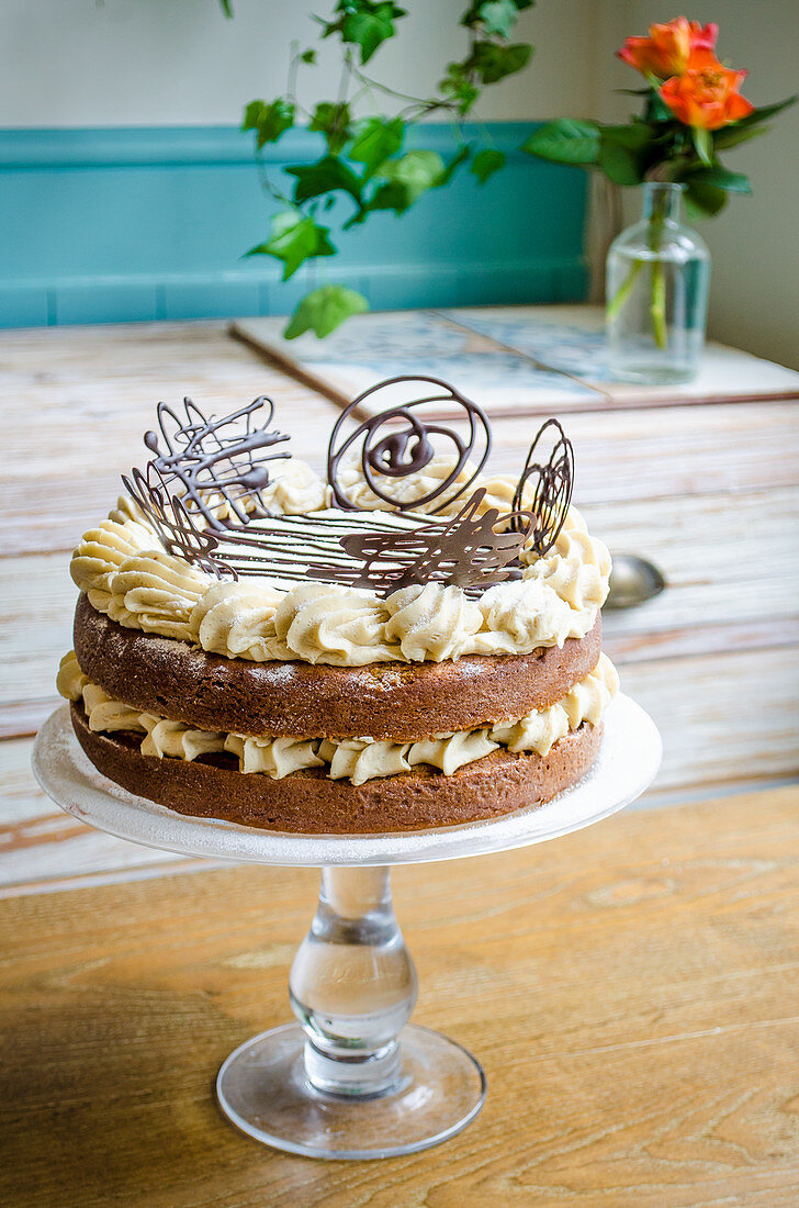 A buttercream cake with filigree chocolate decorations