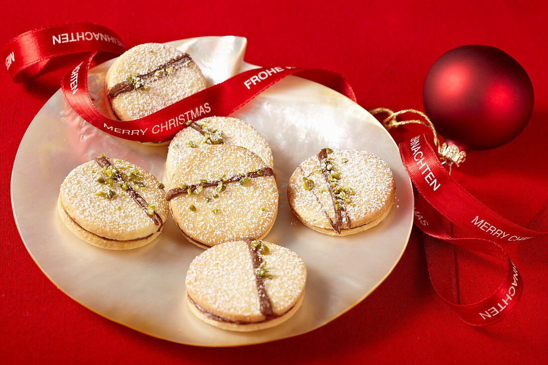 Chocolate spread biscuits with pistachios, lemon and blackberry jelly