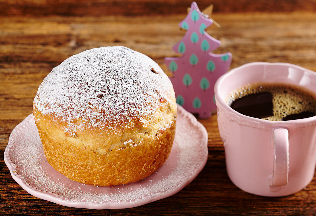 A mini Panettone with a cup of coffee