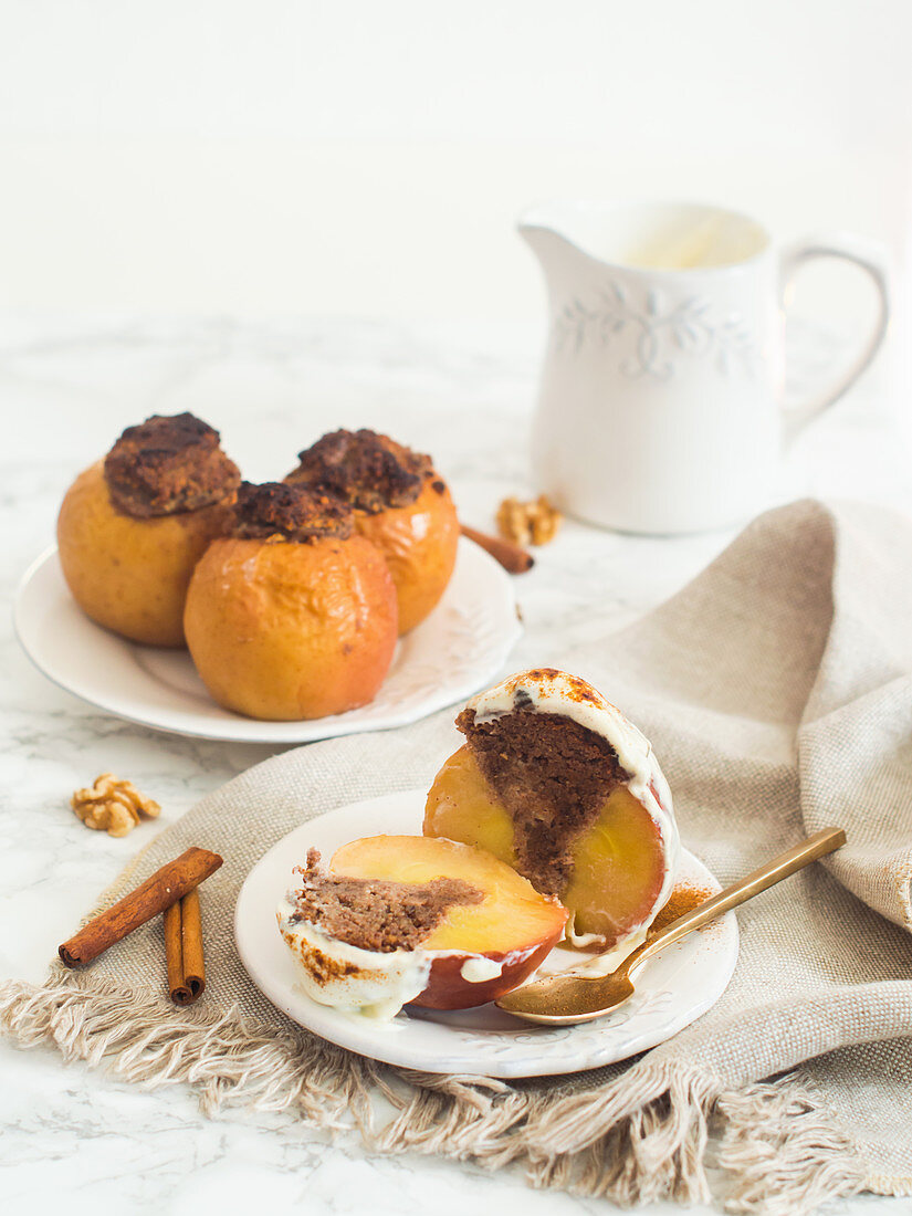 A baked apple filled with dates and walnuts served with yoghurt