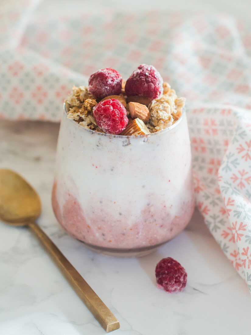 Chia pudding with yoghurt and raspberries served with granola