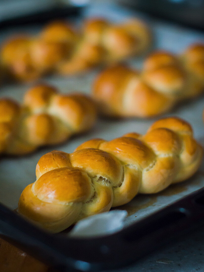 Brioche plaits on a baking tray