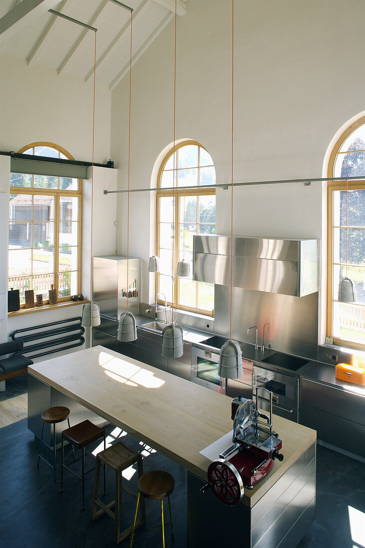 Island Counter With Barstools In License Image 12507710 Image   12507710 Island Counter With Barstools In Converted Loft With Arched Windows 