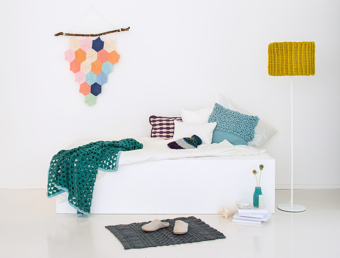Crocheted living accessories: a wall hanging, cushion covers, a lamp shade, a rug and a blanket