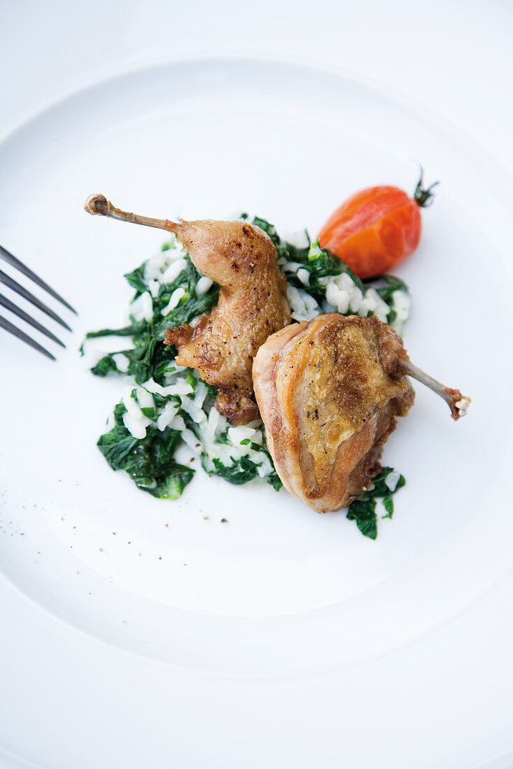 Roasted quail on a bed of spinach risotto