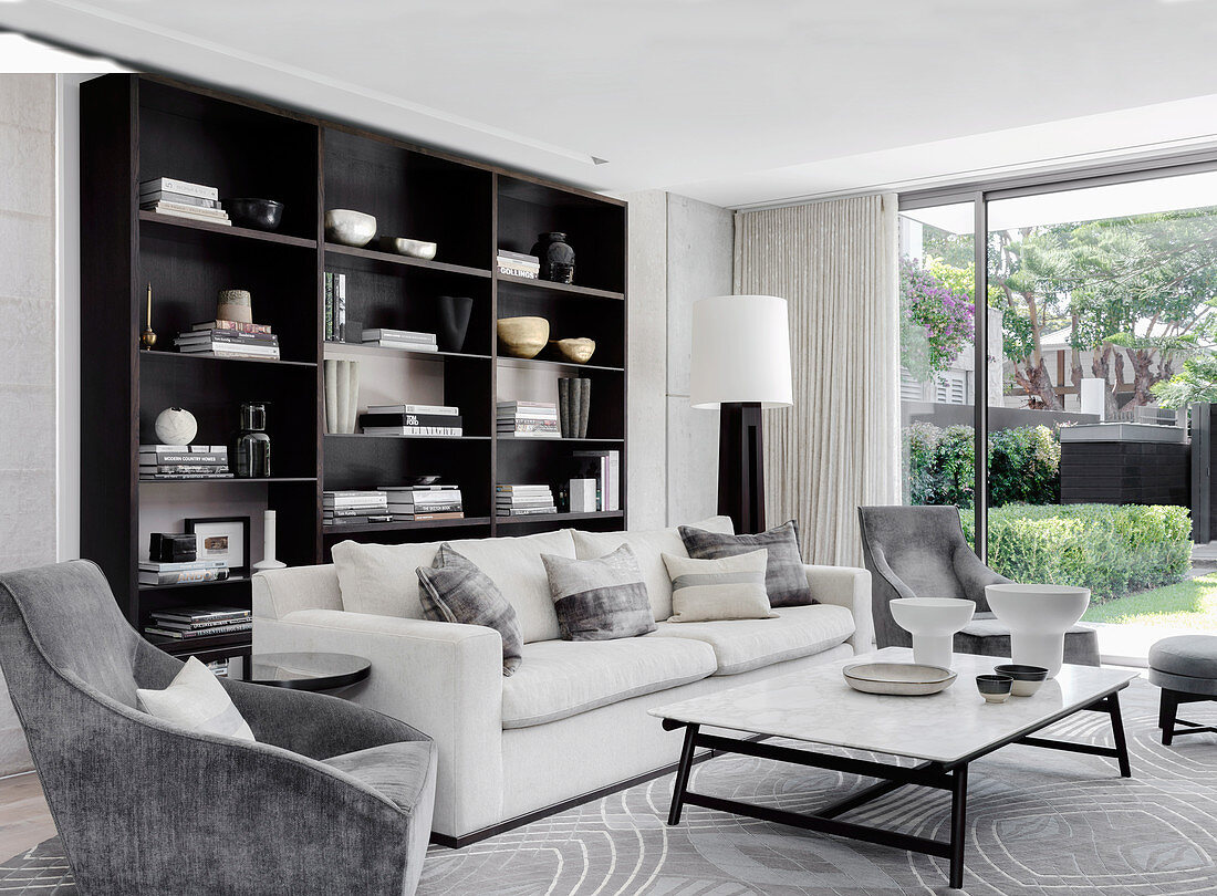 Elegant living room with upholstered furniture and shelves