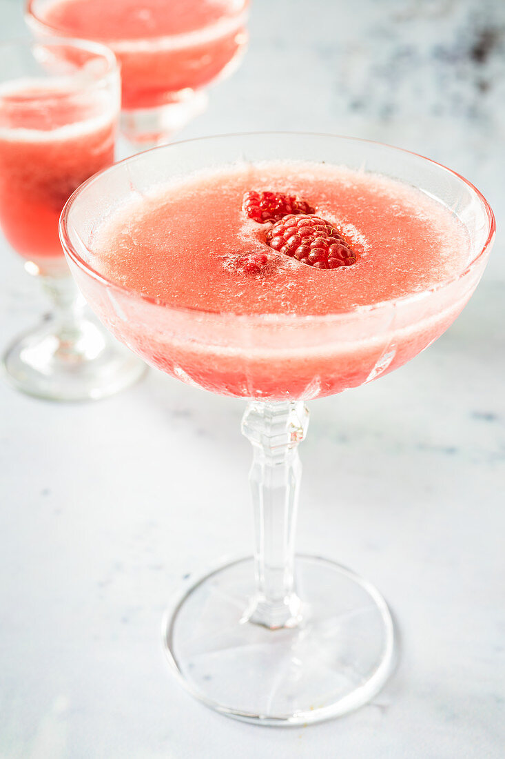 Frozen rosé wine with raspberry syrup and raspberries