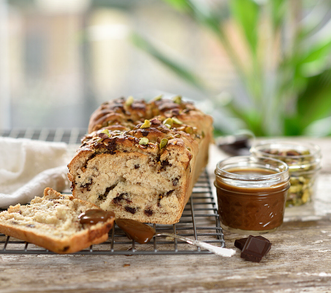 Vegan bread with a quark and chocolate filling sprinkled with pistachio nuts with caramel sauce