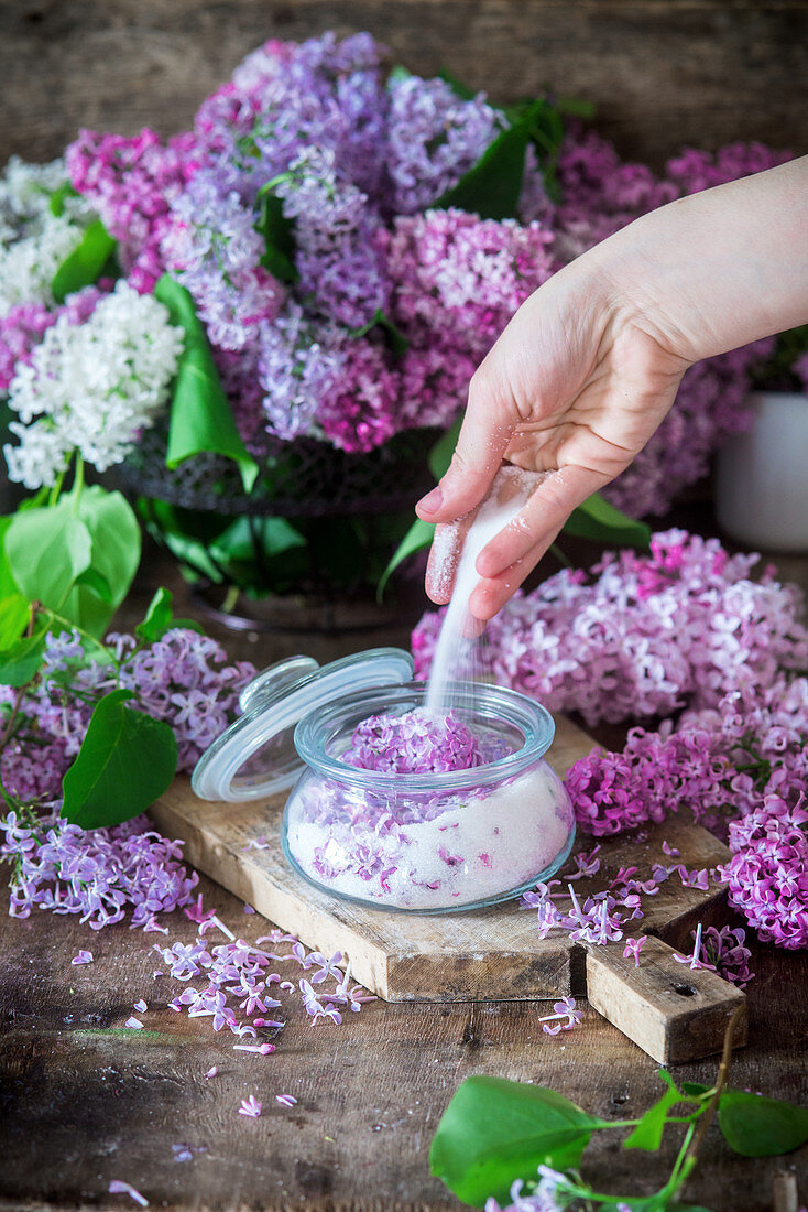 Sugar and lilac flowers being mixed