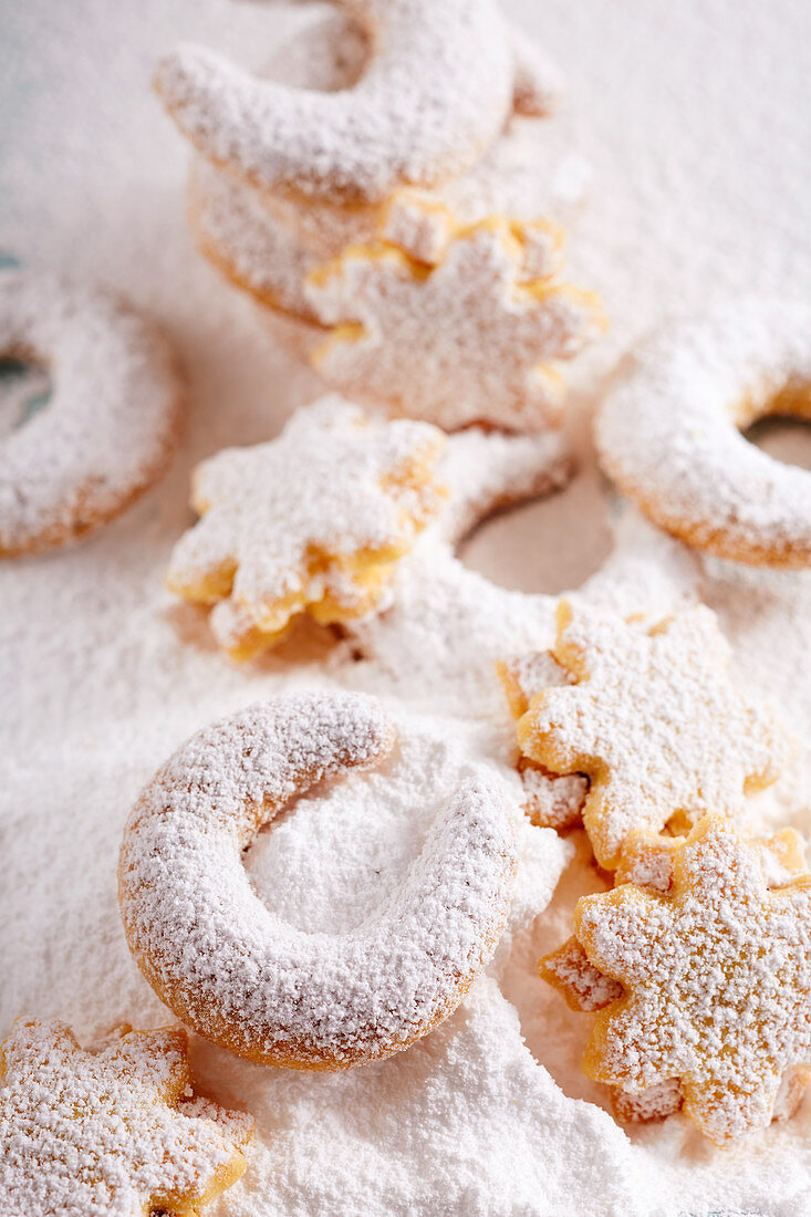 Vanilla crescent biscuits and shortbread almond stars in icing sugar