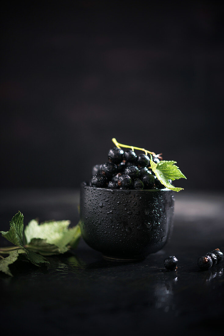 Blackcurrants in a black bowl