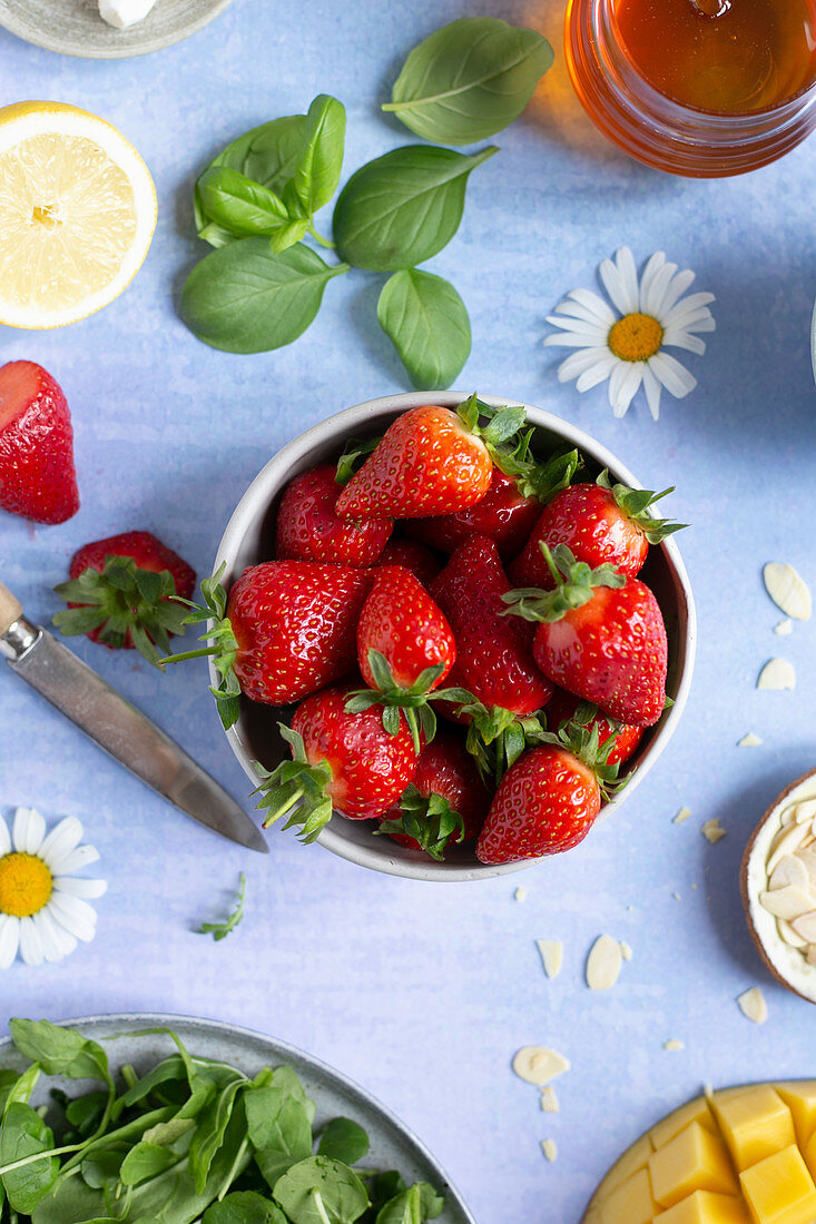 Small bowl of fresh strawberries on a vibrant background