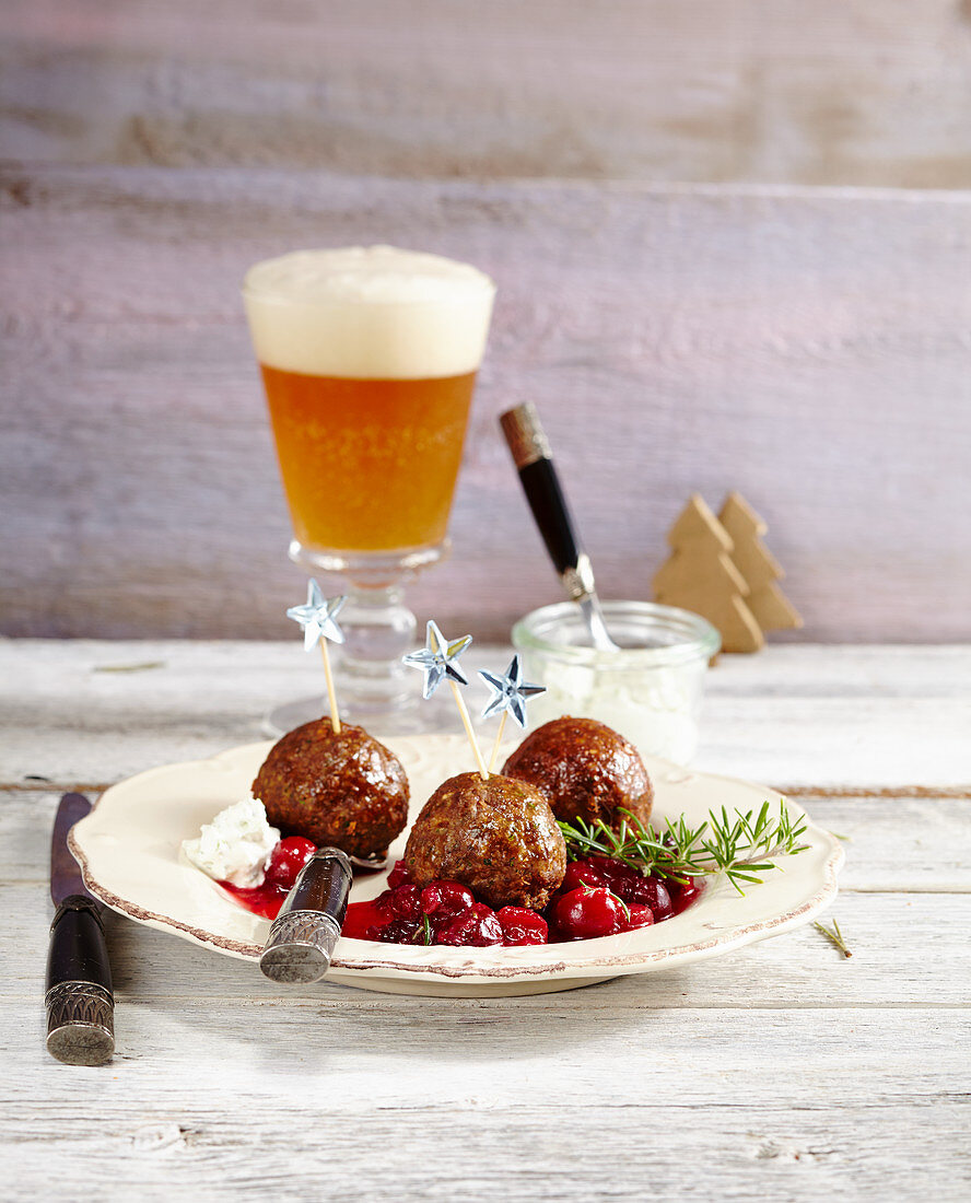 Meatballs with cranberry sauce and parsley sour cream