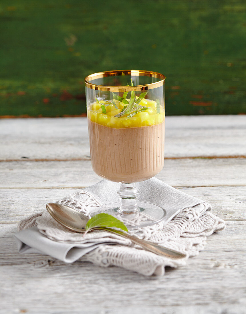 Chocolate and espresso cream with pineapple ragout in a glass