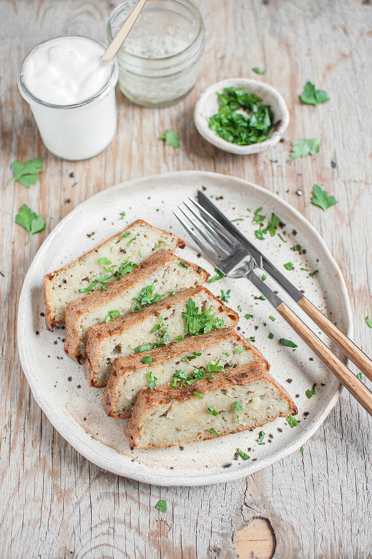 Traditional Polish potato cake served with chopped parsley and yoghurt