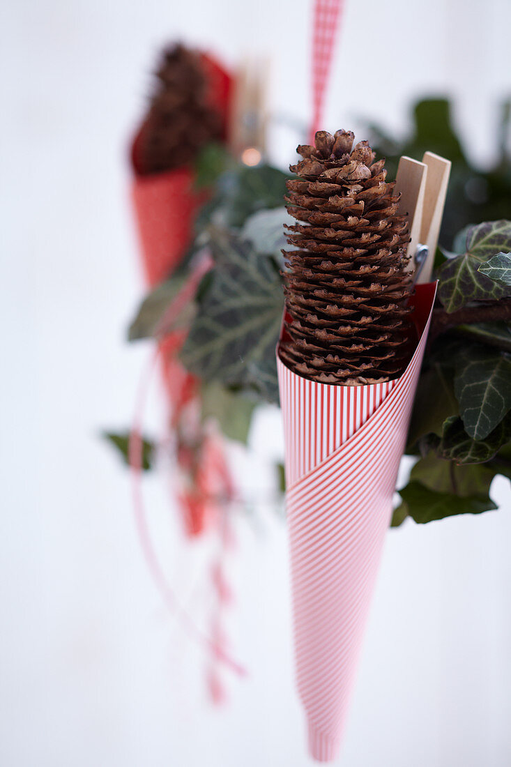 Garland of ivy festively decorated with paper cones and candy canes (detail)