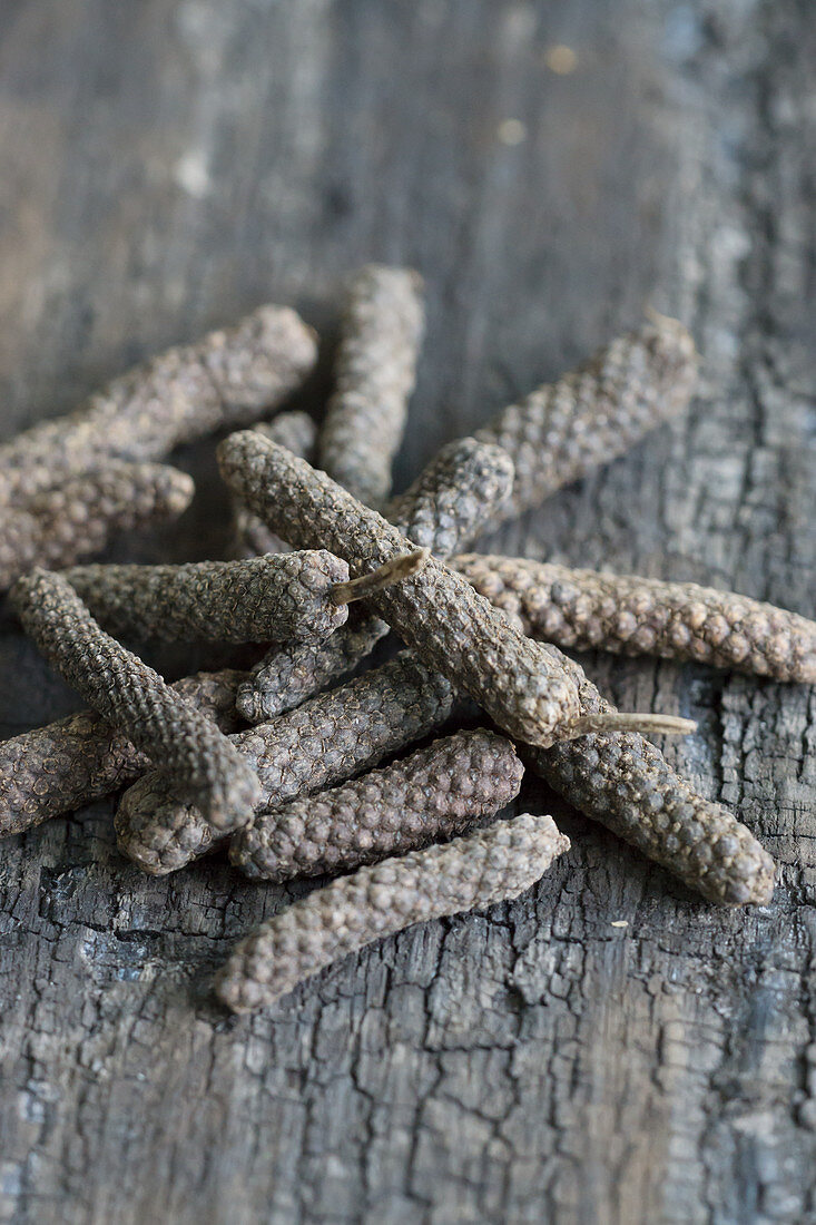 Long pepper on a wooden background